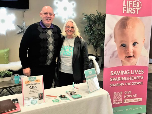 A life first fundraising event with two key members, Judy and Pastor Greg, hosting the booth.