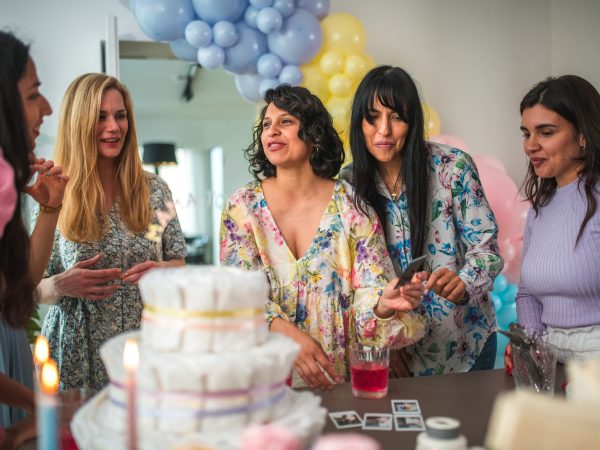 Group of young woman having a baby shower hosted with the help of donors.